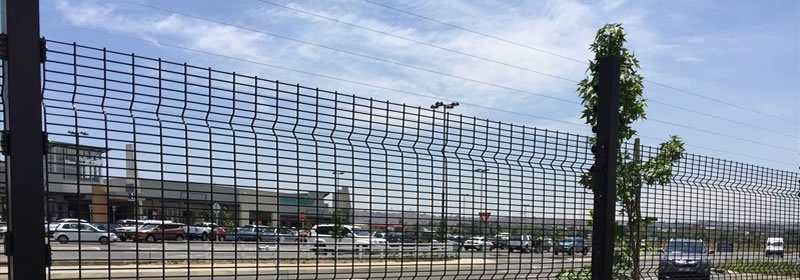 Black medium security clearview fence along a parking area boundary