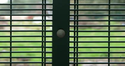 Green 358 mesh fencing with overlap and post fixing arrangement
