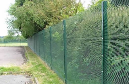 Installed green 3D welded mesh fence beside a landscaped area