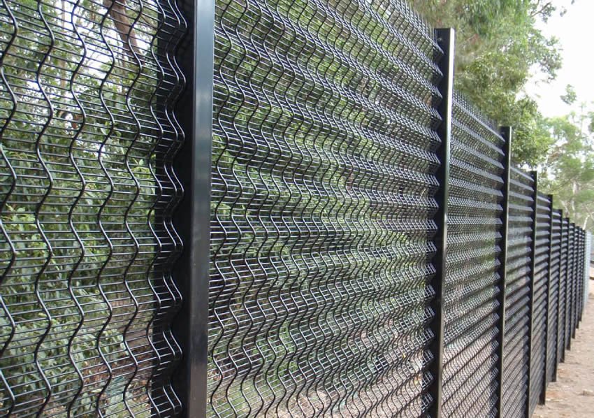 China 3d security fence with black curved welded mesh panels along a landscaped boundary