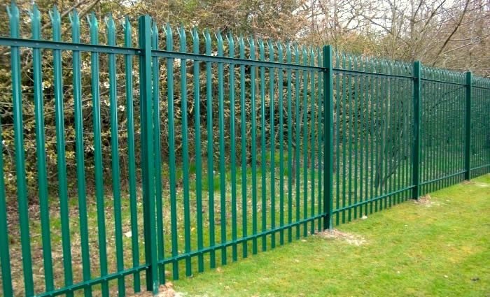 Green-coated W-section palisade fencing used along a property boundary