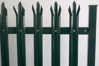 Green palisade fence with W-section steel pales and supporting posts