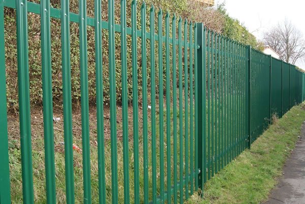 Green coated steel palisade fencing for industrial boundary and landscape setting