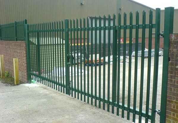 Steel palisade security gate showing matching vertical pales and supporting gate frame