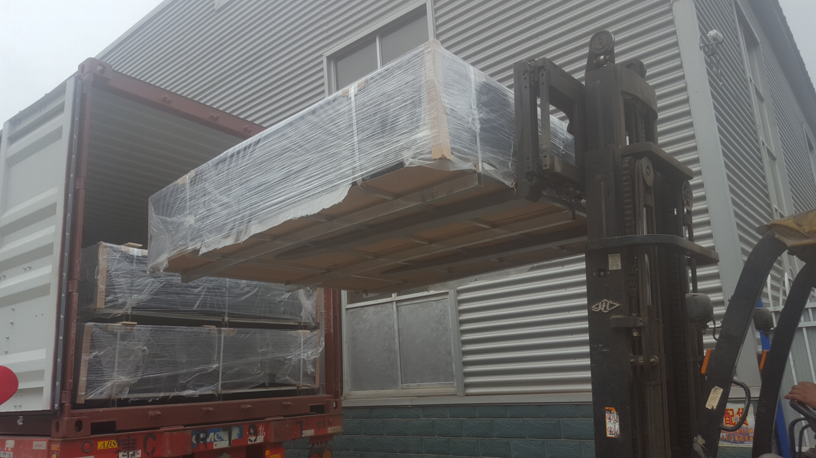 BMP coated security fence panel pallets wrapped and lifted for export container loading
