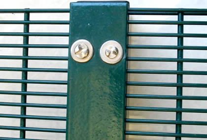 2D welded security mesh panel installed on a steel post with specialized fence brackets